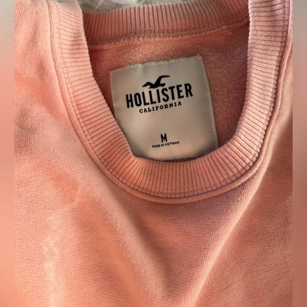 Medium pink Hollister cropped crewneck. Hollister printed on the side.